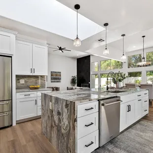 a large kitchen with a center island