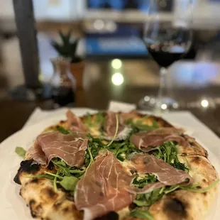 a pizza and a glass of wine