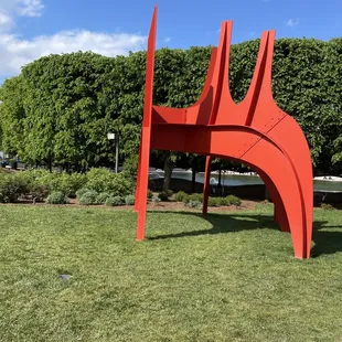 a red sculpture in a park