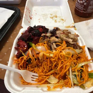 a plate of noodles, meat and vegetables