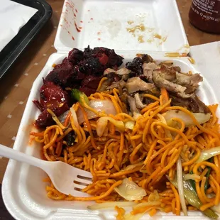 a plate of noodles, meat and vegetables