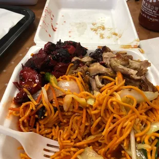 a plate of noodles with meat and vegetables
