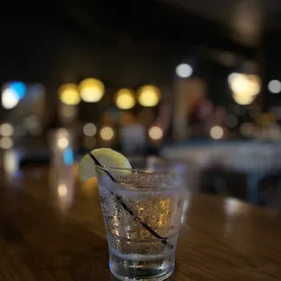 a glass of water with a lemon wedge