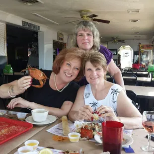 three ladies eating crab