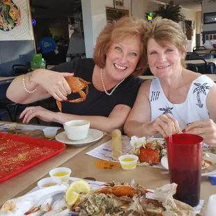 two women eating crab
