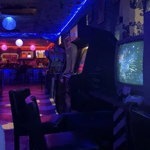 people playing video games in a bar