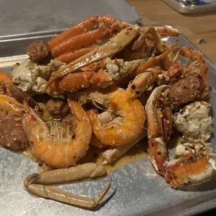 a pile of crab legs and shrimp