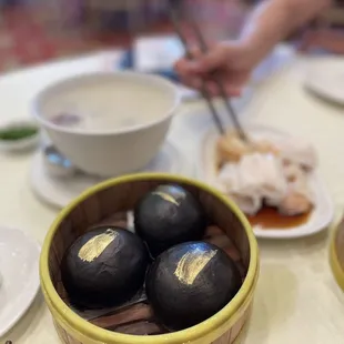 a bowl of food on a table with chopsticks