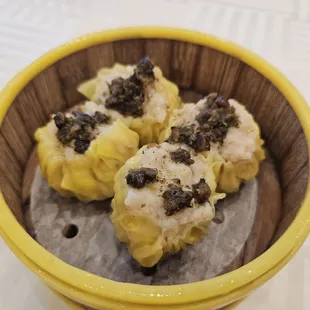 Pork and shrimp dumpling with truffle sauce.