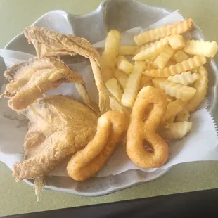 a basket of fried fish and fries