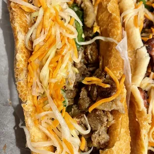 two hot dogs with cheese and onions