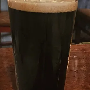 a glass of dark beer