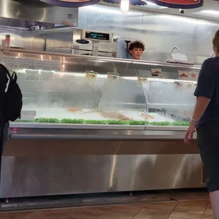 two people standing in front of the counter