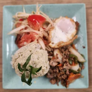 Locomotives plate with rice, curry paste, meat,salad and fried egg