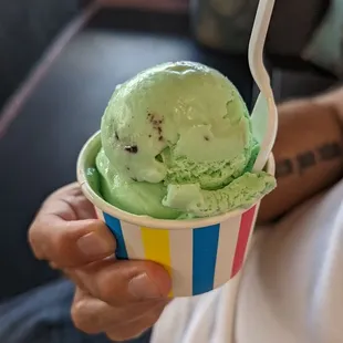 a person holding a cup of ice cream