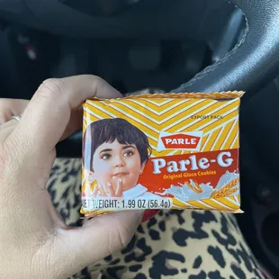 a hand holding a packet of pale - g