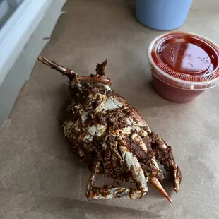 a crab on a table with ketchup
