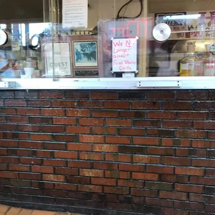 a brick wall with a clock on it