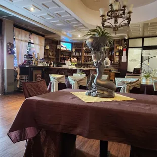 Beautiful quaint place with a bar and a banquet hall on the other side.