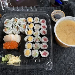 Miso soup, salmon roll with cucumber, tuna roll, yellowtail roll, ikura, and scallop