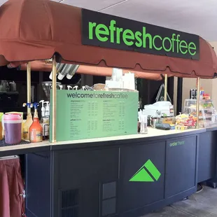 a coffee station with a sign that says refresh coffee