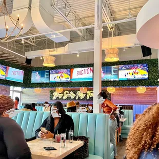 people sitting at tables in a restaurant