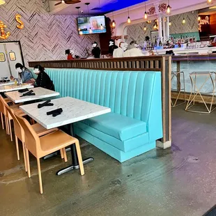 a restaurant with blue booths and tables