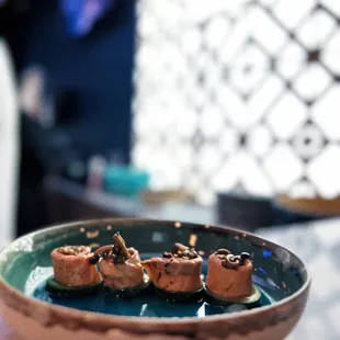 three sushi rolls on a plate