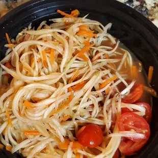 a plate of noodles and tomatoes