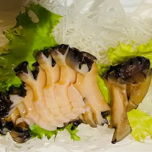 a close up of a sandwich with lettuce and mushrooms