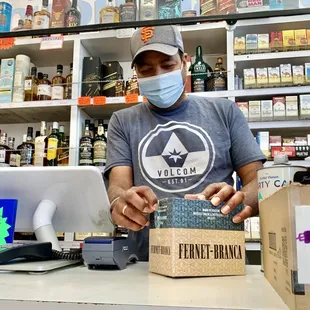 Raj stocking the excellent liquor wall