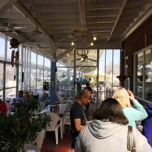 people sitting at tables in a restaurant