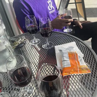 a man sitting at a table with wine glasses