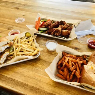 Oyster po boy with sweet potato fries, alaskan cod with fries, cajun chicken wings
