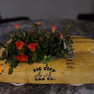 a yellow taxi with flowers in it