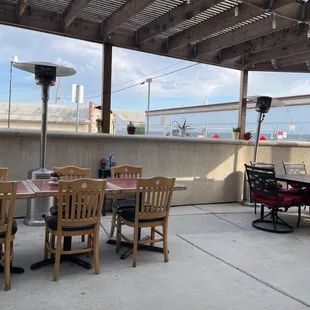 a patio with tables and chairs