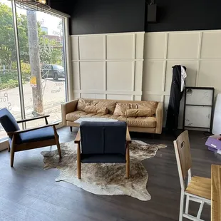 a living room with a couch, chairs, and a table