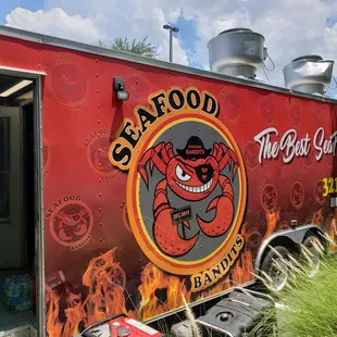 a red food truck with a cartoon character painted on the side