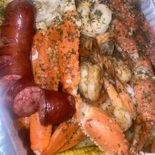 crab legs, shrimp, corn, sausage, and corn on the cob