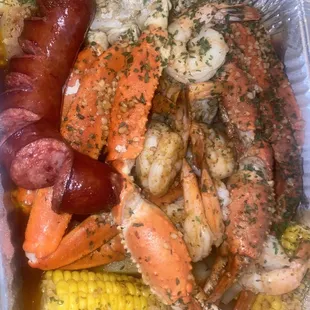 shrimp, crab legs, corn on the cob, and sausage