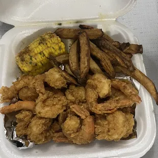 a container of fried shrimp and corn