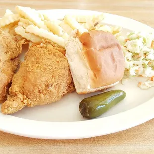 fried chicken, coleslaw, and pickle on a plate