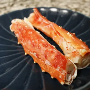 two pieces of crab legs on a blue plate