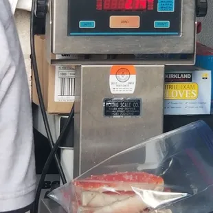 Premium “Merus” Cut Red King Crab being measured out.