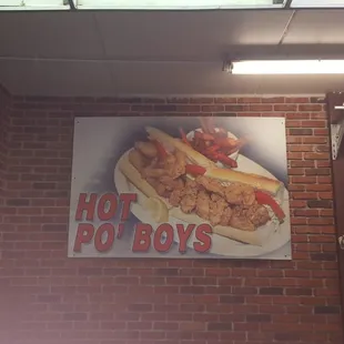 a hot dog boy sign on a brick wall