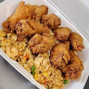 fried chicken and rice in a styrofoam container