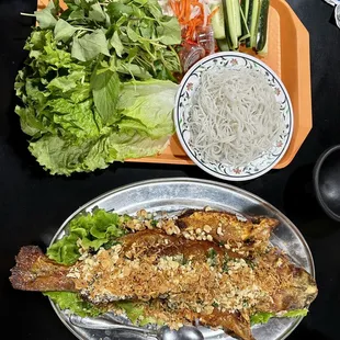 a plate of vegetables and a bowl of noodles