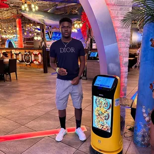 a man standing in front of a food vending machine