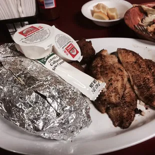 Blackened catfish, hush puppies and baked potato