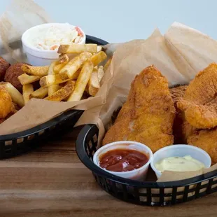two baskets of fried fish and fries